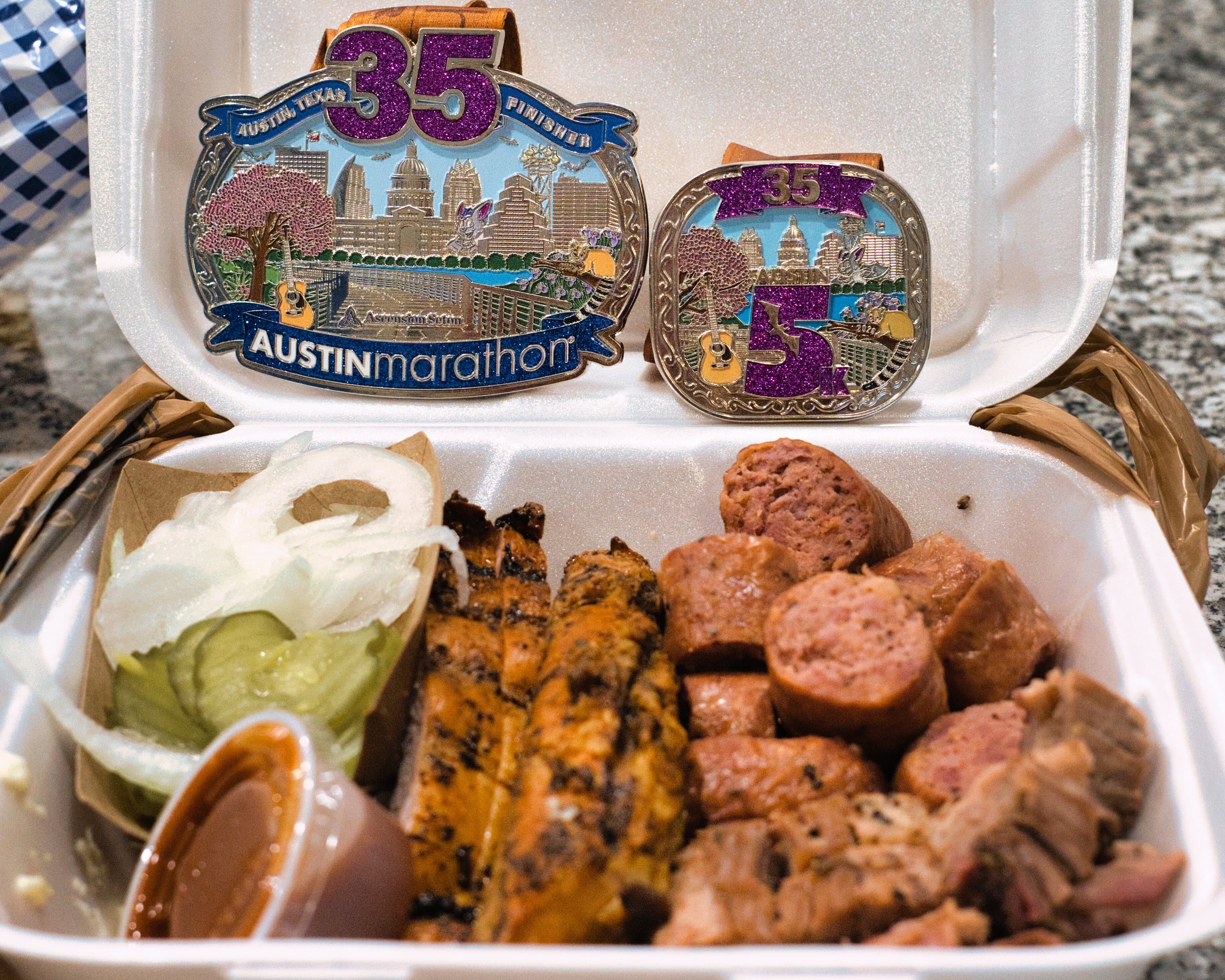 Austin Marathon medals with BBQ celebration
