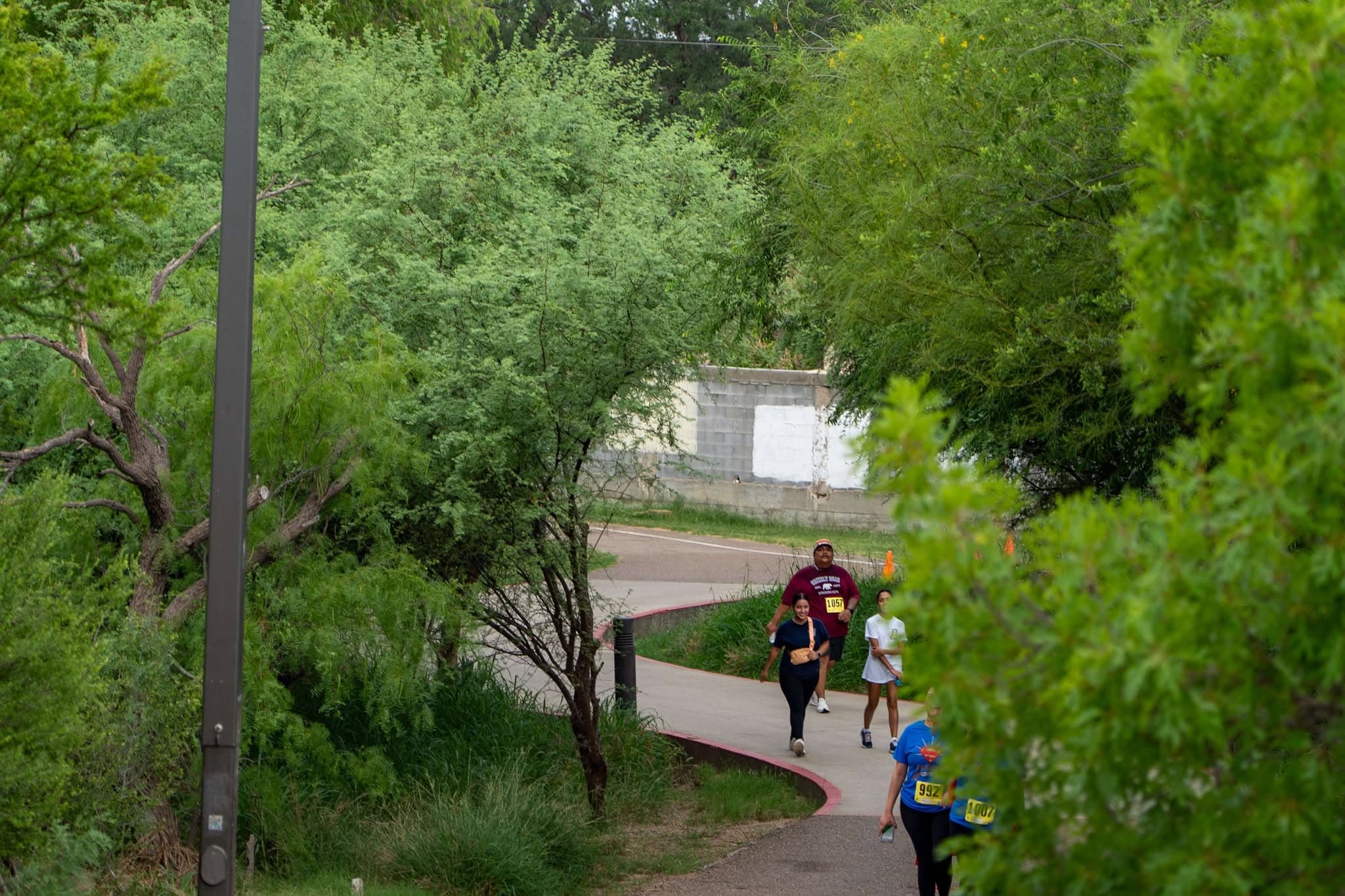 Volunteer handing water to runners